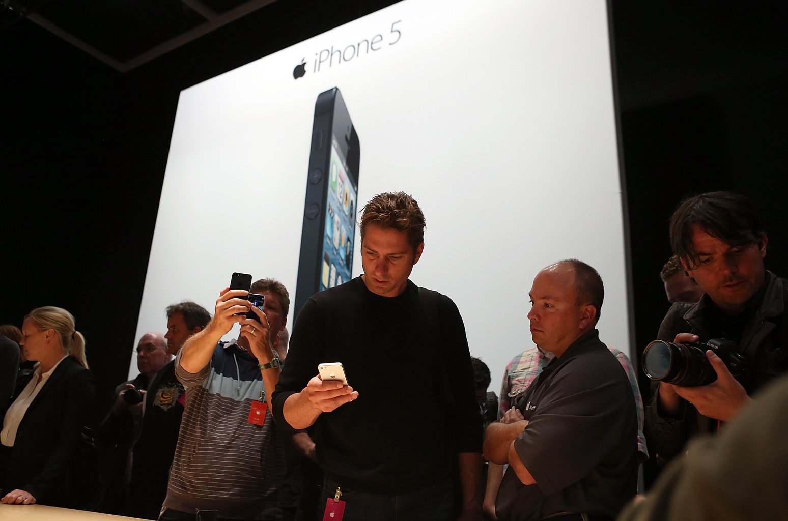 Attendees look at the new iPhone 5 during an Apple special event at the Yerba Buena Center for the Arts on September 12, 2012 in San Francisco, California. Apple announced the iPhone 5, the latest version of the popular smart phone as well as new updated versions of the iPod Nano, Shuffle and Touch. (Photo by Justin Sullivan/Getty Images) 