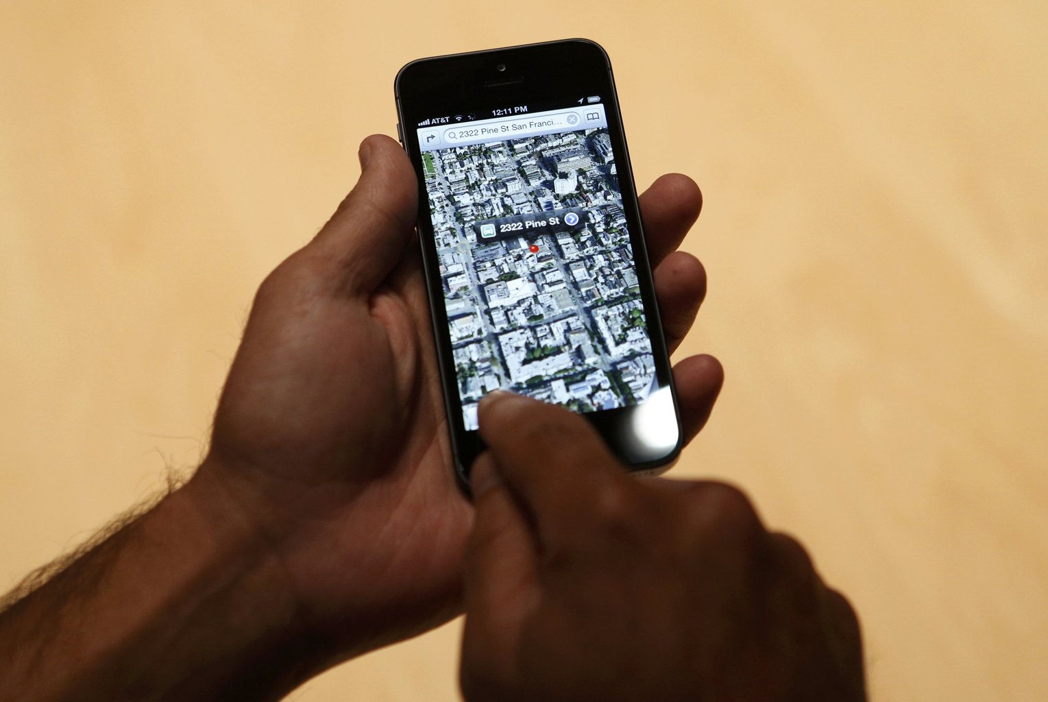 A member of the media uses the map function of iPhone 5 after its introduction during Apple Inc.
