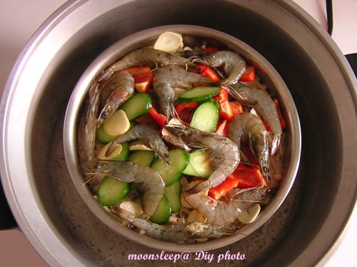 第一次電鍋開關跳起,放下海鮮及小黃瓜、青椒、大蒜片,再按下開關蒸10分鐘 第一次電鍋開關跳起,放下海鮮及小黃瓜、青椒、大蒜片,再按下開關蒸10分鐘