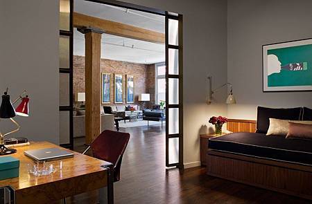 Brick-Wall-Studio-Apartment-by-Stephan-JAKLITSCH-GARDNER-hardwood-floor-bedroom-with-walnut-desk-and-japanese-style-double-doors.jpeg