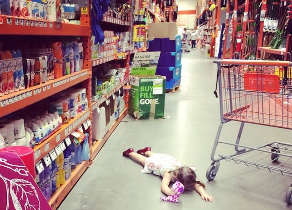 young_girl_laying_on_a_floor_at_a_store.jpg