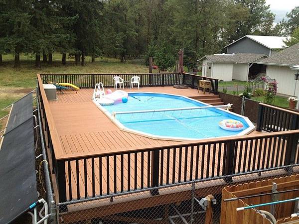 Contemporary-oval-above-ground-pool-with-wooden-deck-and-railing.jpg Contemporary-oval-above-ground-pool-with-wooden-deck-and-railing.jpg