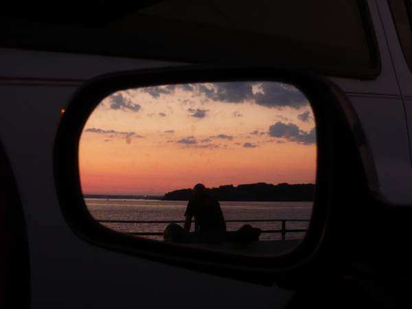 The reflectiono of a stranger in my driving mirror