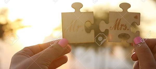 106517675-woman-hands-holding-mr-and-mrs-sign-during-sunset-time-harmony-and-wedding-concept.jpg