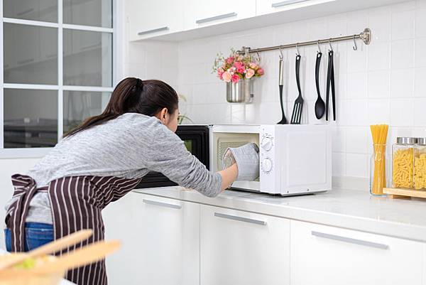woman-putting-bowl-with-vegetables-microwave-oven.jpg