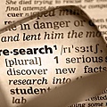 research_word_in_dictionary_magnified_sepia
