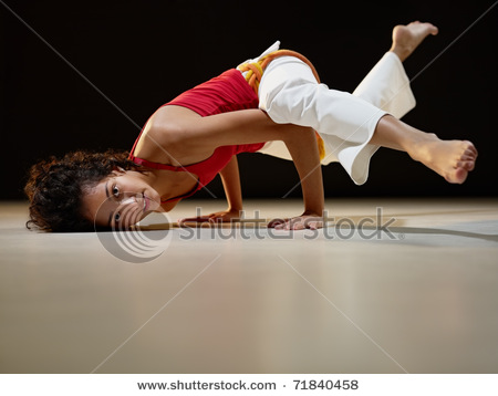 stock-photo-portrait-of-young-adult-latin-american-female-doing-yoga-and-capoeira-in-gym-horizontal-shape-71840458