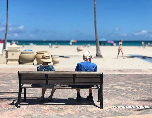 man-and-woman-sitting-on-brown-wooden-bench-1034597.jpg