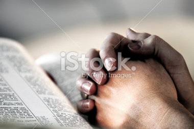 stock-photo-1262149-praying-hands-over-a-holy-bible