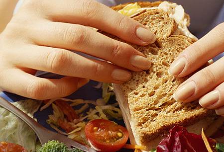 getty_rf_photo_of_woman_eating_sandwich