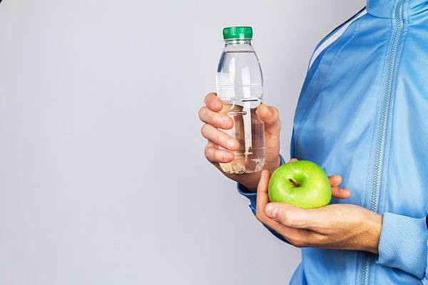 person-holding-a-bottle-of-water-and-an-apple_1220-827.jpg