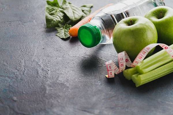 close-up-of-healthy-food-with-water-bottle-and-tape-measure_23-2147601749.jpg