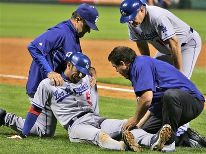 080918 Nomar Garciaparra is helped by Stan Conte as Joe Torre and Larry Bowa look on after injuring his left knee rounding third base on a fifth-inning single by Pablo Ozuna against the Pirates.jpg