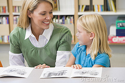 teacher-helping-student-reading-skills-6081835.jpg