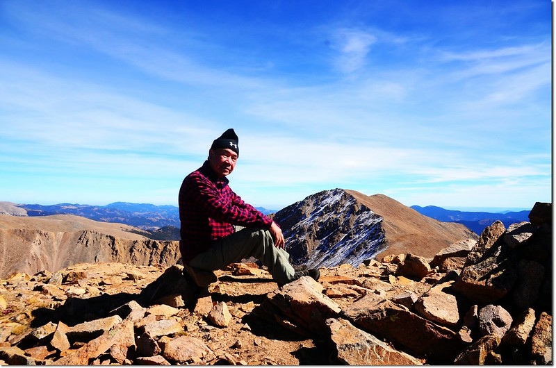 On the summit of Mount Parnassus, in the background is Bard Peak