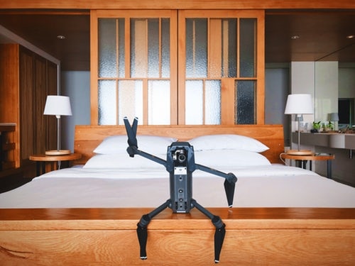 black quadcopter drone on brown wooden table.jpg