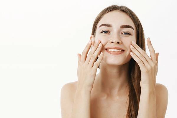 charming-relaxed-gentle-young-woman-making-cosmetological-procedure-applying-facial-cream-face-with-fingers-smiling-broadly-feeling-perfect-taking-care-skin_176420-24010.jpg