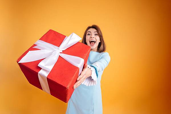 graphicstock-happy-excited-young-woman-giving-you-gift-box-over-yellow-background_B_GCPuRLhe.jpg