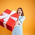 graphicstock-happy-excited-young-woman-giving-you-gift-box-over-yellow-background_B_GCPuRLhe.jpg