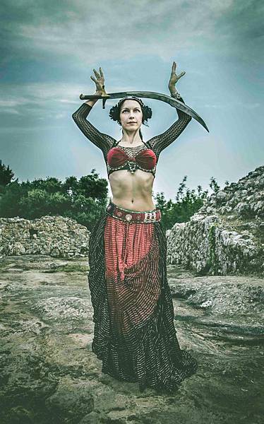 woman-wearing-black-and-red-dress-holding-sword-standing-on-115782.jpg