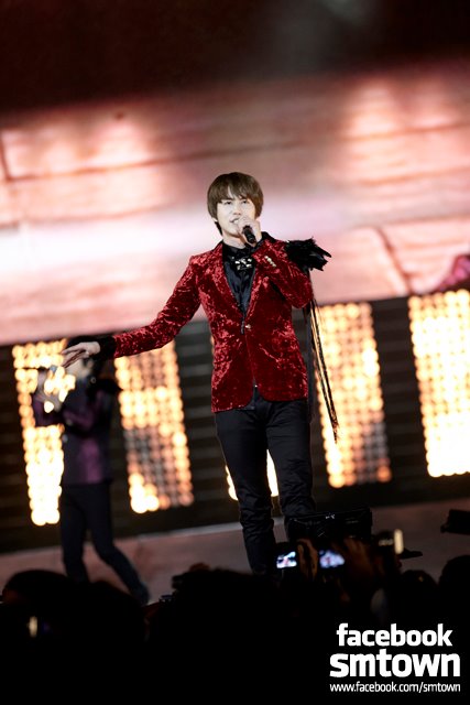 Super Junior's Kyuhyun is singing passionately on the stage.