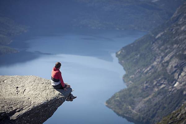 man-sitting-on-trolltunga-rock-in-norway-2.jpg