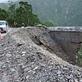 橋墩斷裂，路面被掏空，僅容一車通行。-1.JPG