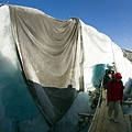 Because of ablation, parts of the tunnel's roof have disappeared and protective sheets are hanging d