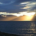 Evening sunlight breaks through storm clouds above the dissected tableland north of Van Keulenfjorde