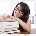 stock-photo-beautiful-smiling-girl-in-a-classroom-with-book-67116739.jpg