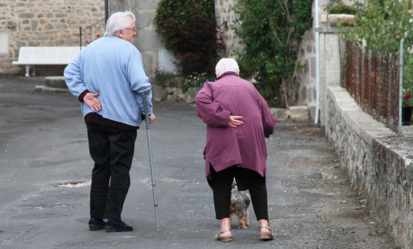 Image-of-an-elderly-couple-supporting-their-backs-and-walking-with-canes.-.png