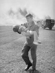 Spencer Bailey, a young survivor, being carried to safety by Lt. Colonel Dennis Nielsen after the crash..jpg