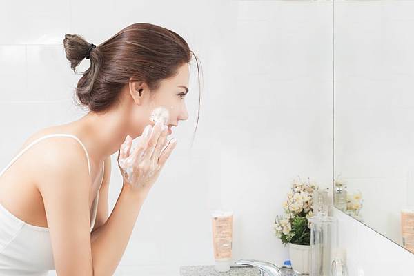 side-view-of-mid-adult-woman-washing-face-while-royalty-free-image-1583379667.jpg