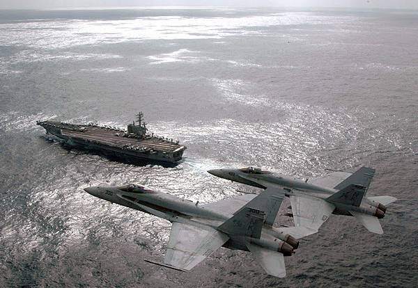 US_Navy_070301-N-1689P-002_Capt._Craig_Williams%2525252C_foreground%2525252C_and_Capt._Richard_Butler_fly_F-A-18C_Hornets_above_USS_Ronald_Reagan_%25252528CVN_76%25