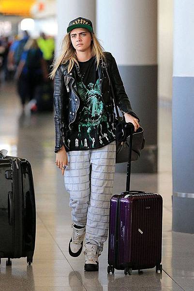 Cara Delevingne with her purple Rimowa carry-on roller