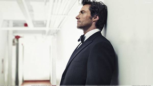 Hugh Jackman In Black Coat Side Pose