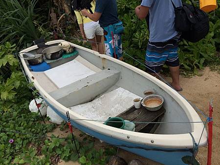 野人家大門口小船上放鍋子 接雨水用的