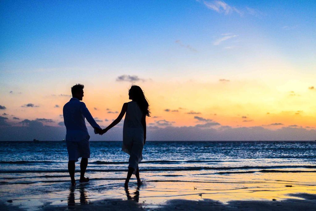 man-and-woman-holding-hands-walking-on-seashore-during-1024960.jpg