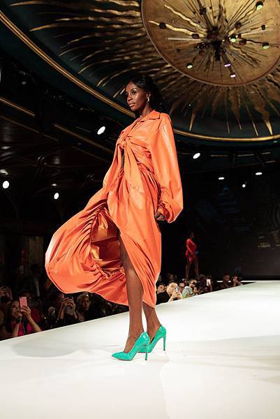woman-in-orange-long-sleeve-dress-standing-on-white-floor-3011499.jpg