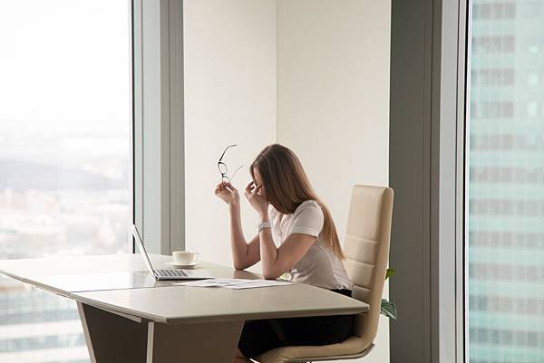 exhausted-businesswoman-sitting-office.jpg