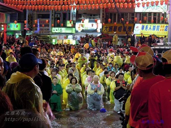 大甲媽祖遶境出發前穿著雨衣在鎮瀾宮前貴敗的虔誠信徒(南海道人攝)