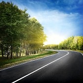 11646092-empty-curved-road-blue-sky-and-sun