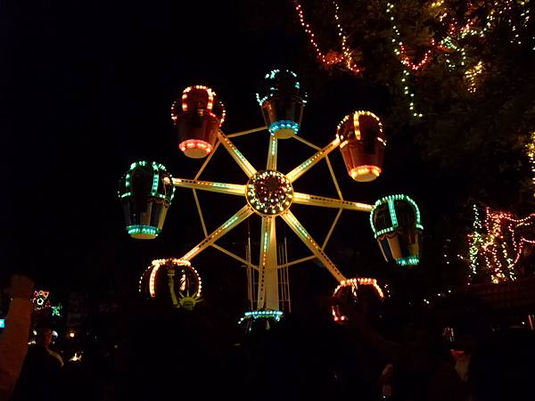 the hotel is in a plaza, and there is a ferris wheel