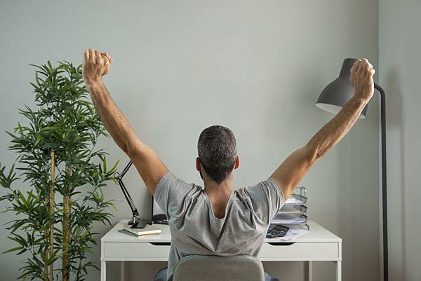 back-view-man-stretching-his-arms-while-working-from-home.jpeg