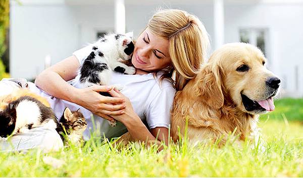 woman-pets-dog-cat-lawn-garden