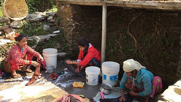 Women in village washing clothes in kuwa