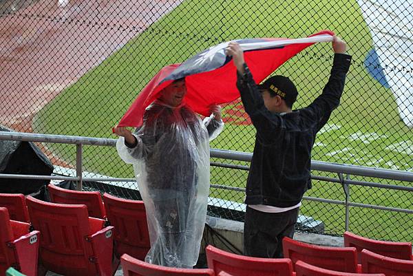 愛國球迷在雨中舉旗吶喊！