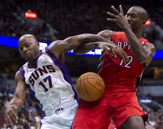 Sun Chucky Atkins, left, knocks the ball away from Toronto's Ronald Dupree, a fellow former Piston, in Vancouver on Wednesday, Oct. 6, 2010. (AP).jpg