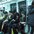People_engaging_with_their_phones_on_the_Seoul_Metro_-_5166351572_4e33242d3e_o.jpg
