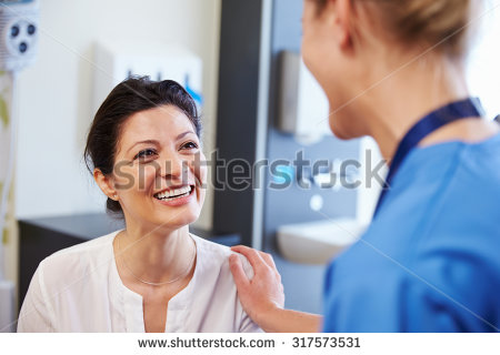 stock-photo-female-patient-being-reassured-by-doctor-in-hospital-room-317573531.jpg